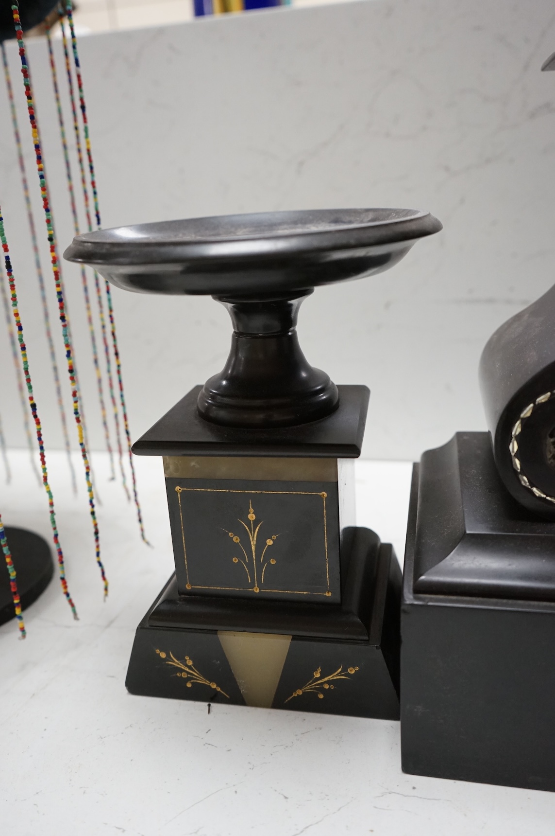 A Victorian slate clock garniture with enamelled chapter ring and mercury pendulum, 47cm high